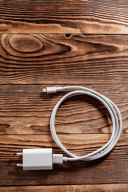 Cable phone chargers on wood background