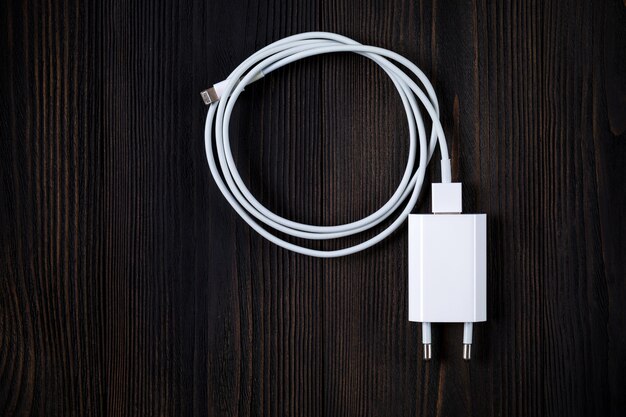 Cable phone chargers on wood background