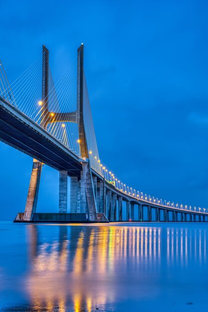 The cable-stayed vasco da gama bridge across the river tagus in lisbon portugal at dusk