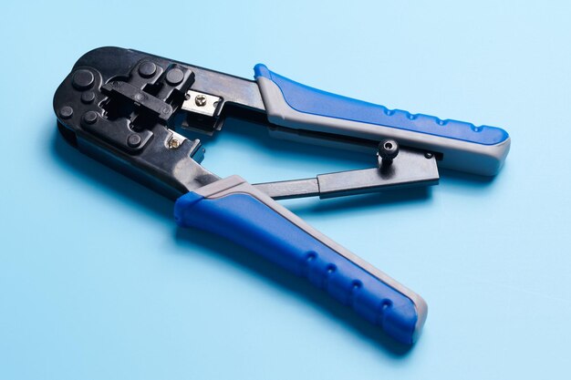 Cable stripping and crimping tool wire strippers isolated on\
blue background