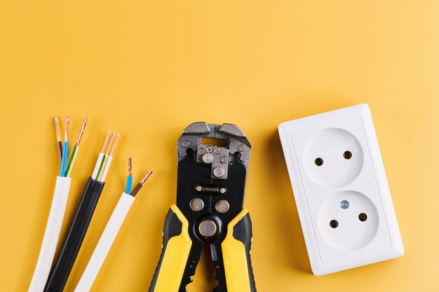 Cable stripping and crimping tool wire strippers isolated on\
yellow background