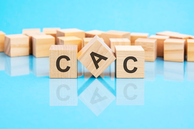 CAC text is made of wooden building blocks lying on the bright blue table concept