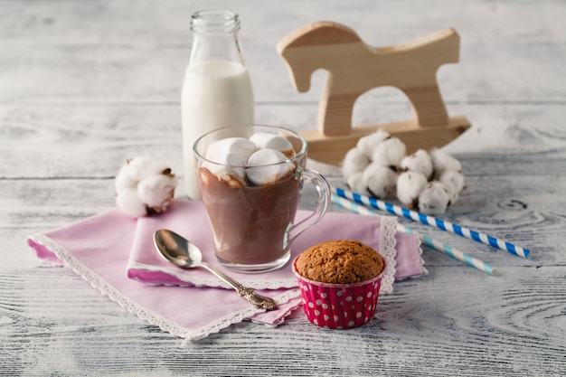 Cacao drink in the mug and old horse toy