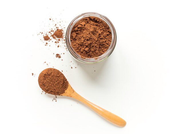 Cacao powder with a spoon and a crystal jar