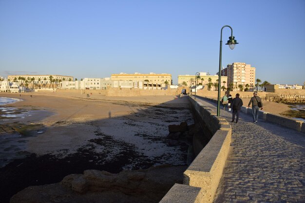 Cadiz Spain 06 november 2019 La Caleta with the San Sebastian Castle La Caleta island in the background View from Paseo Fernando Quinones Promenade