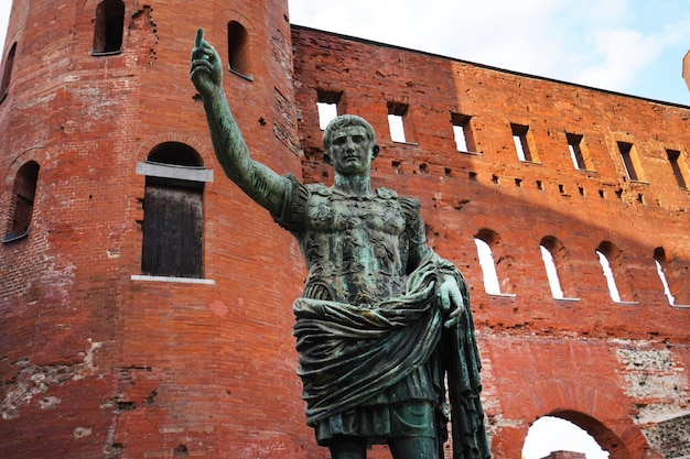 Caesar Augustus bronze statue in front of Palatine Gate in Turin, Italy