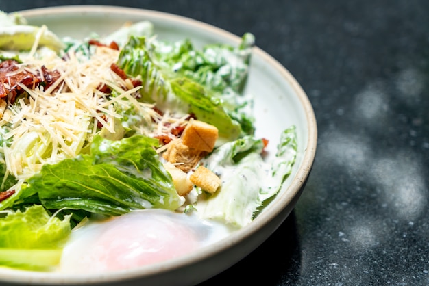 Caesar salad bowl with egg