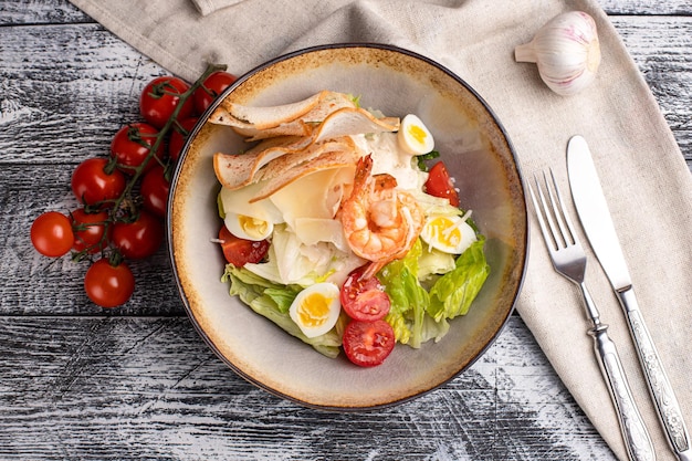 Caesar salad caesar with shrimp salad on a white background side view