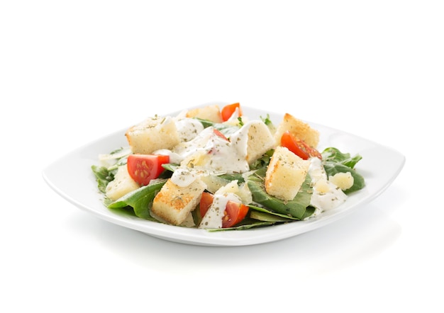 Caesar salad in plate isolated on white