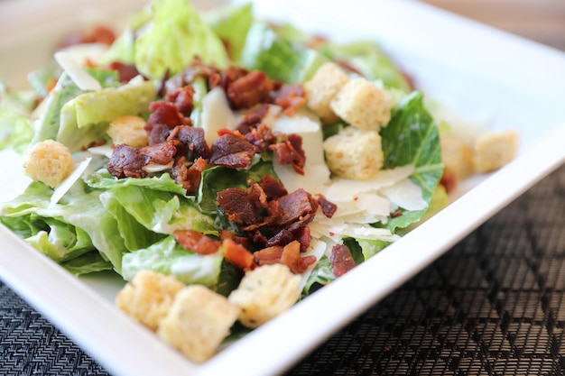 Caesar salad , vegetable with bread bacon and cheese