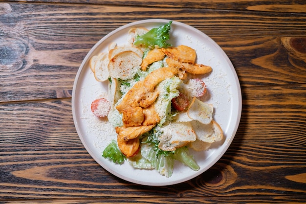 Caesar salad with chicken cheese and cherry tomatoes