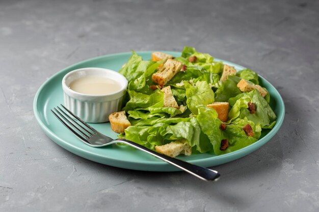 Caesar salad with croutons and bacon.