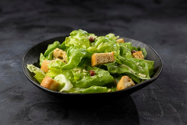 Caesar salad with croutons and bacon.