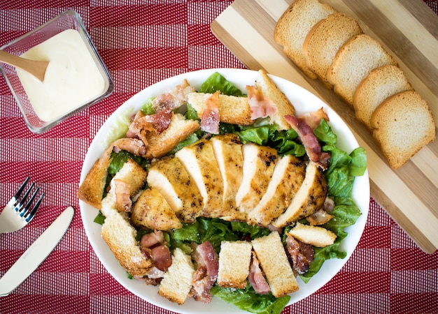 caesar salad with grilled chicken on toast