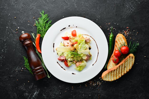 Caesar salad with salmon and fresh vegetables Top view Free space for your text