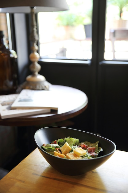 Caesar salad on wood background