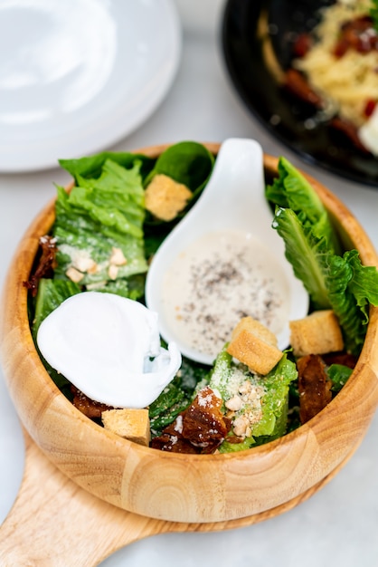 caesar salad on wood bowl