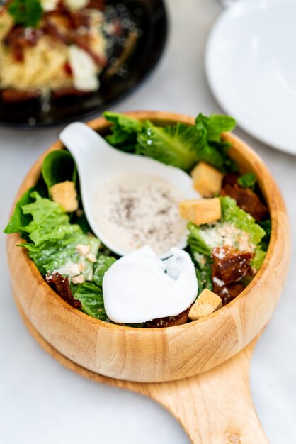 caesar salad on wood bowl