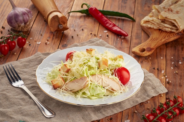 Caesar salad on wooden background, vegetarian food