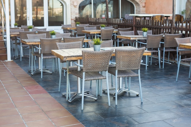 Cafe, coffee shop, tavern and restaurant concept - Outdoor street cafe tables ready for service.