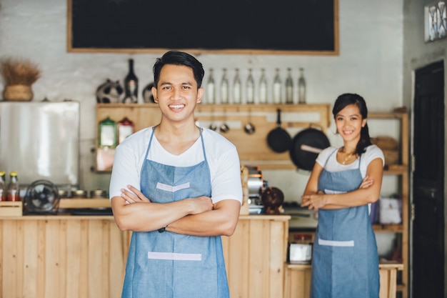 Cafe employees standing with crossed arms