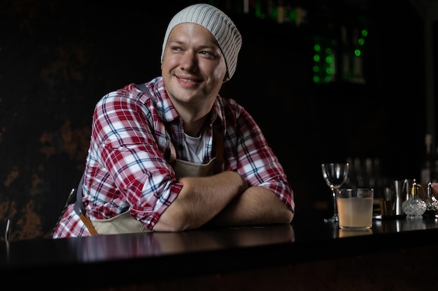 Cafe owner Pleasant delighted man sitting near the counter smiling