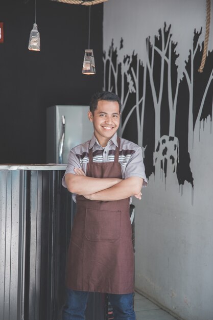 Cafe owner standing with crossed arms