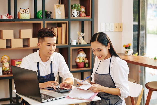 Cafe owners checking bills