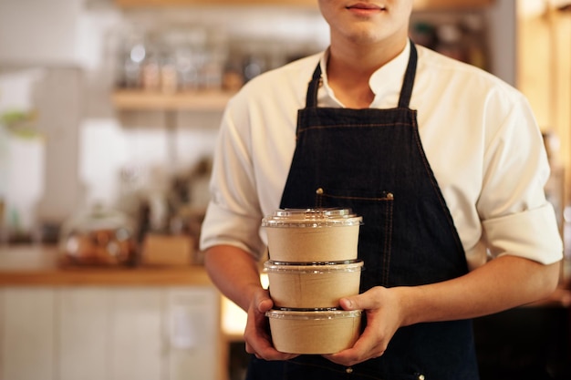 Cafe Waiter Holding Paper Containers