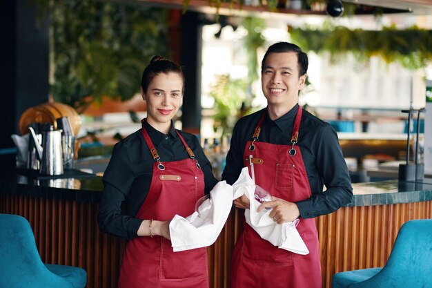 Cafe waiters cleaning glassware