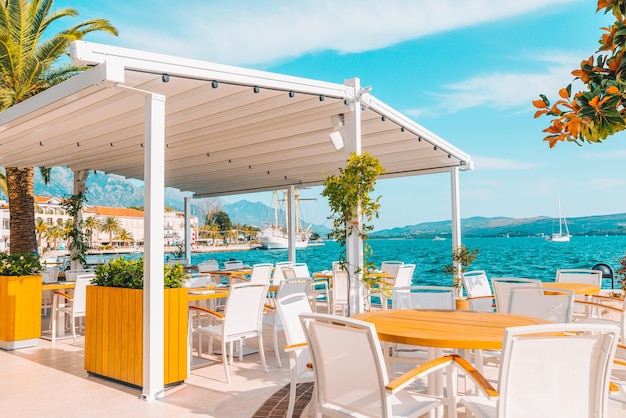 Cafe with beautiful view at blue sea water mountains on background summer time