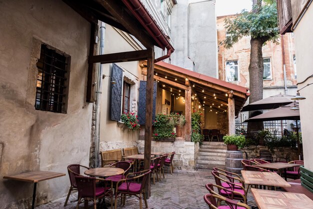 Cafe with terrace and wooden tables in city