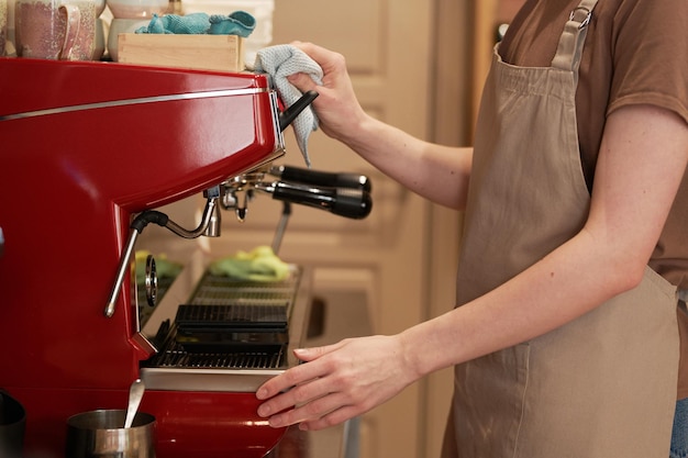 Cafe Worker Cleaning Coffee Machine