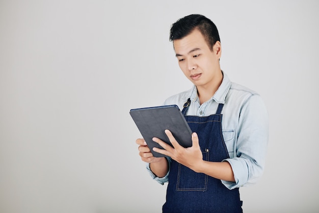 Cafe worker reading order on tablet