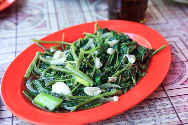 Cah Kangkung Tumis Stir Fry Water Spinach on Red Plate