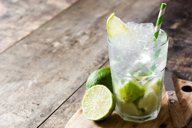 Caipirinha cocktail in glass on wooden table 