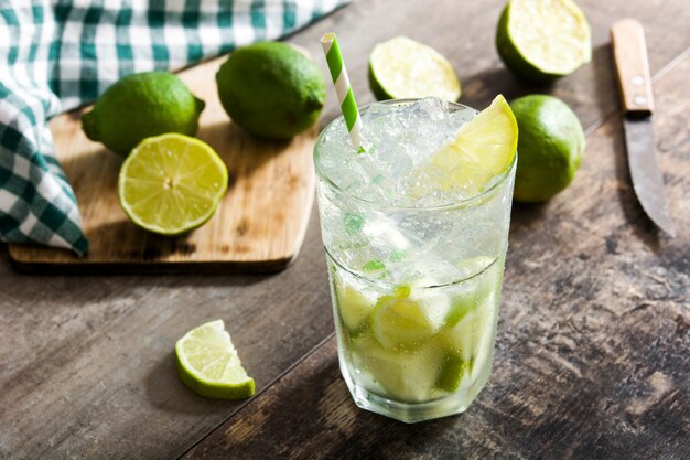 Caipirinha cocktail in glass on wooden table