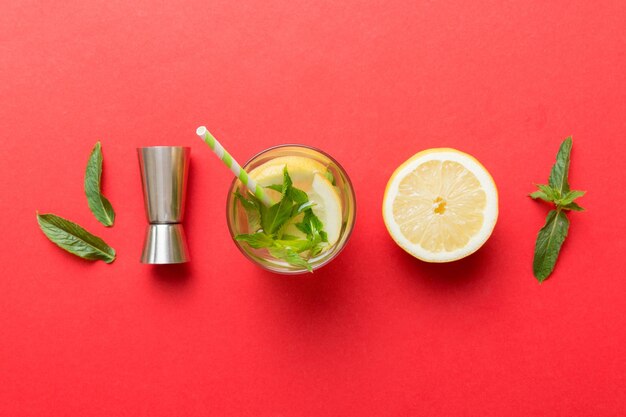 Caipirinha Mojito cocktail vodka or soda drink with lime mint and straw on table background Refreshing beverage with mint and lime in glass top view flat lay