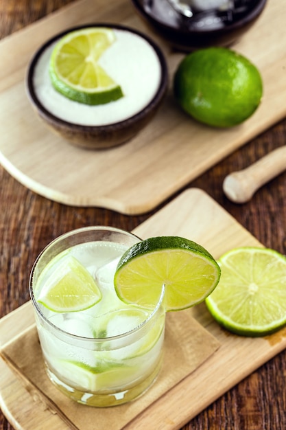 Caipirinha with ingredients. Lemon, sugar, ice and alcohol. Brazilian drink based on cachaca