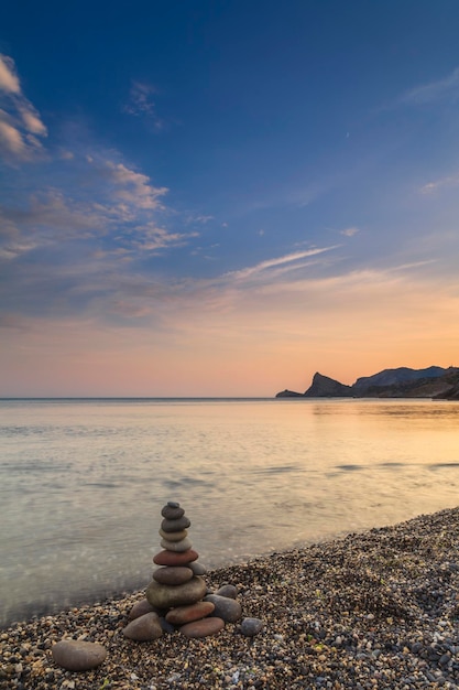 Cairn on the seashore Scenic evening seascape