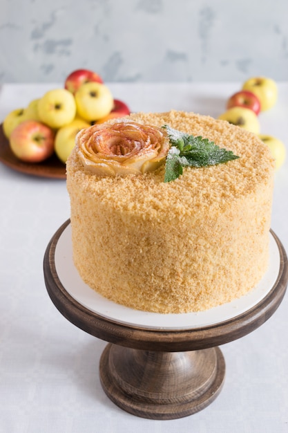 Photo cake and apples on a light surface