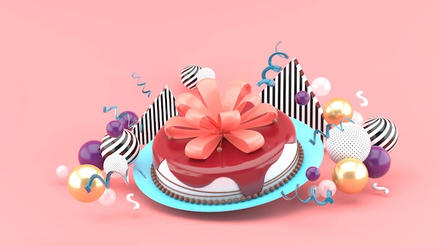 Cake and bow among colorful balls on a pink space