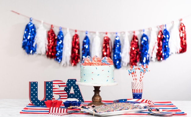 Photo cake, cookies, and fruit and vegetable snack tray at the july 4th celebration party.