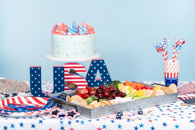 Cake, cookies, and fruit and vegetable snack tray at the July 4th celebration party.