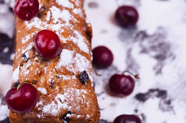 Cake cupcake with raisins and cherries homemade sweet pastries powdered sugar selective focus blurred soft toned photo