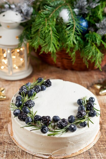 Cake decorated with blackberries on the christmas table