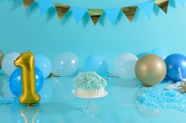 Photo cake decorated with blue flowers on a photo studio background