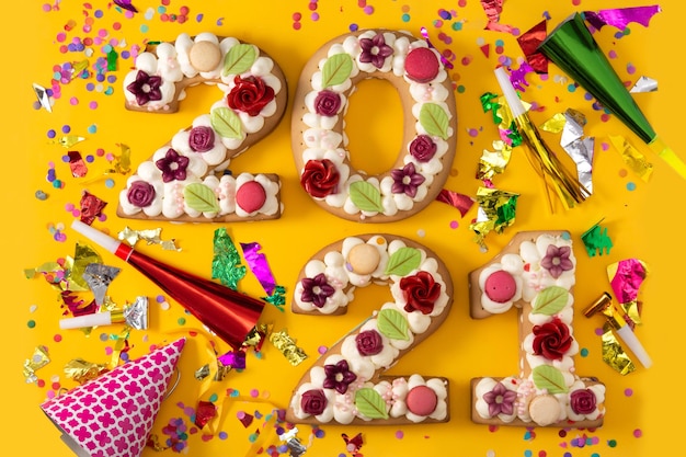 Cake decorated with flowers isolated on yellow background