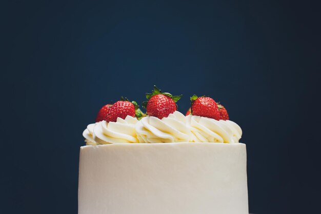 Photo cake decorated with isomalt shape and strawberries on blue background