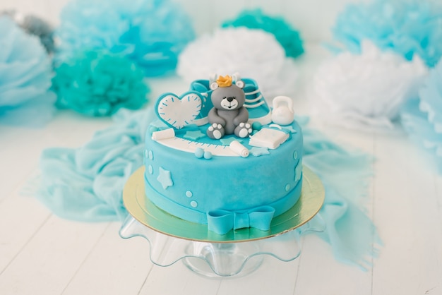青のクマと男の子の最初の誕生日のケーキ。